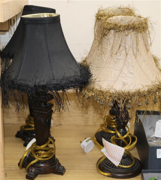 A pair of small table lamps with black shades and a pair of bronzed metal table lamps, with beige shades